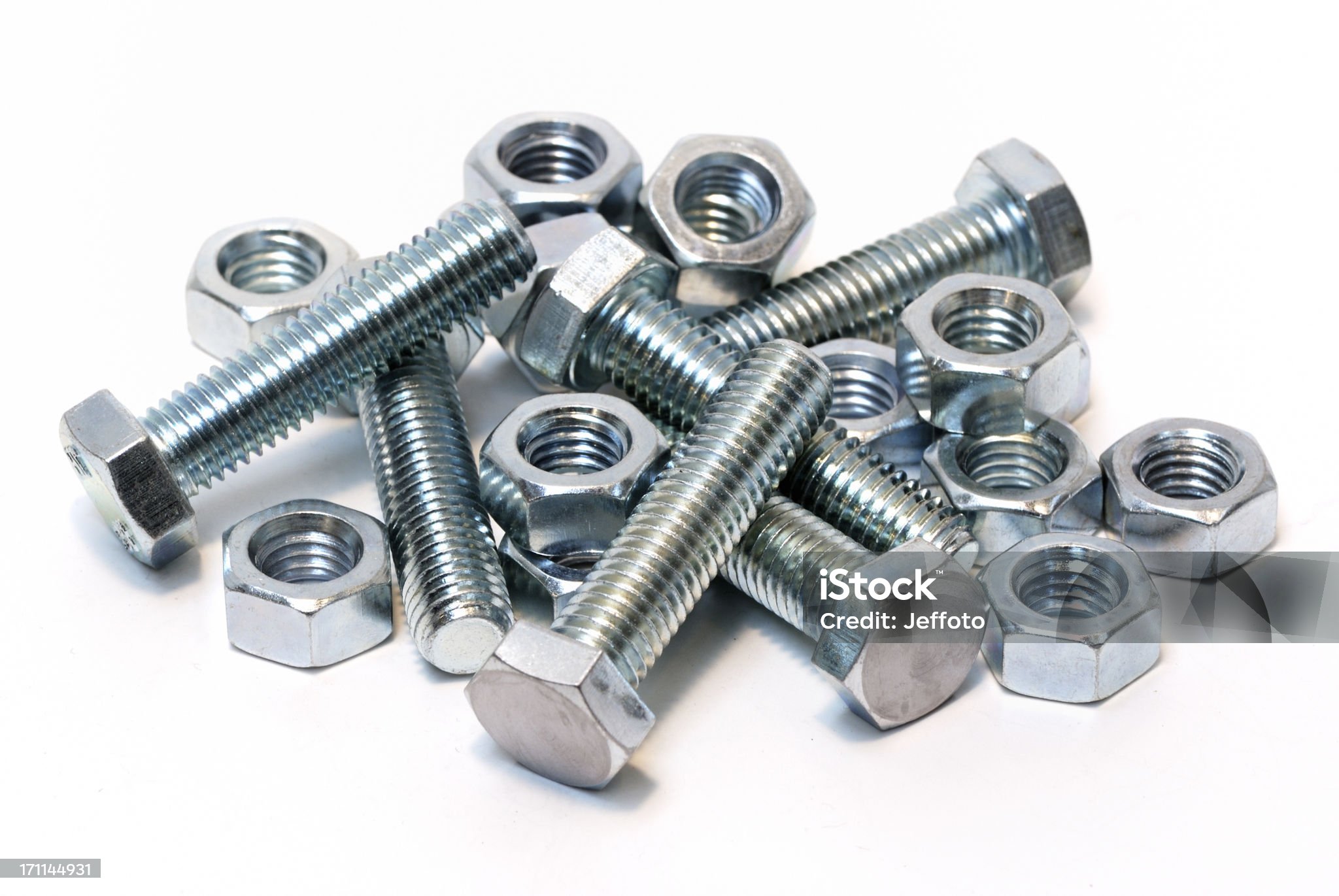group of steel nuts and bolts isolated on a white background.